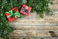 Christmas background with gift box and fir branch on wooden rustic board, festive snow effect, Christmas frame Royalty Free Stock Photo