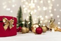 Red round gift box with a Golden bow on the background of Christmas bokeh Royalty Free Stock Photo