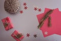 Christmas background with gift boxes, clews of rope, paper and decorations on red. Preparation for holidays Royalty Free Stock Photo