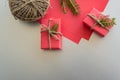 Christmas background with gift boxes, clews of rope, paper and decorations on red. Preparation for holidays Royalty Free Stock Photo