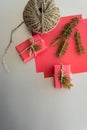 Christmas background with gift boxes, clews of rope, paper and decorations on red. Gift wrapping concept. Top view Royalty Free Stock Photo