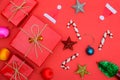 Christmas background with gift boxes, clews of rope, paper's rools and decorations on red. Preparation for holidays. Royalty Free Stock Photo