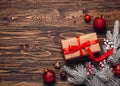 Christmas background with gift boxes in craft paper with red ribbon, Christmas decorations, spruce twigs on rustic dark wooden Royalty Free Stock Photo