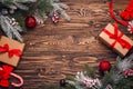 Christmas background with gift boxes in craft paper with red ribbon, Christmas decorations, spruce twigs on rustic dark wooden Royalty Free Stock Photo