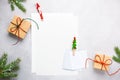 Christmas background with gift boxes, festive decor, fir tree branches and paper cards notes. Flat lay Royalty Free Stock Photo