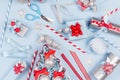 Christmas background - gift boxes in red, blue and silver metallic color with ribbons, decorations, scissors, straws as pattern. Royalty Free Stock Photo