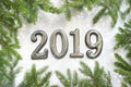 Christmas background with gift, Christmas tree and numbers 2019 on white wooden table. Royalty Free Stock Photo