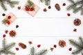 Christmas background with Christmas gift, fir branches, pine cones, snowflakes, red decorations. Xmas and Happy New Year Royalty Free Stock Photo