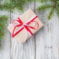 Christmas background with gift and fir tree on white wooden table. Top view with copy space Royalty Free Stock Photo