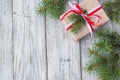 Christmas background with gift and fir tree on white wooden table. Top view with copy space. Royalty Free Stock Photo