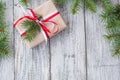 Christmas background with gift and fir tree on white wooden table. Top view with copy space. Royalty Free Stock Photo