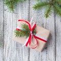 Christmas background with gift and fir tree on white wooden table. Top view with copy space Royalty Free Stock Photo