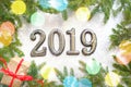 Christmas background with gift, Christmas tree and numbers 2019 on white wooden table. Royalty Free Stock Photo