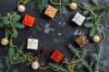 Christmas background with gifts, beads and fir branches, black concrete background. Top view. Flat lay,copy space