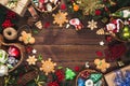 Christmas background with gifts, toys, tree branches, New Year decor, candies, and gingerbread cookies on old wooden background. F Royalty Free Stock Photo