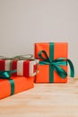 Christmas background. Gifts wrapping in red and brown paper on a light wooden background Royalty Free Stock Photo