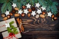 Christmas background with gingerbread cookies, fir branches and presents in boxes on the old wooden board. Copy space. Royalty Free Stock Photo