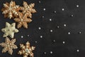 Christmas background with gingerbread cookies in the form of snowflakes on a dark background