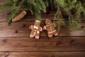 Christmas background. Gingerbread man and Christmas cane on a wooden background.
