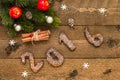 Christmas background with gingerbread numbers 2016, fir branches and decorations on the old wooden board. Royalty Free Stock Photo