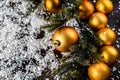 Christmas background. gold baubles a deco on dark black background. copy space. Selective focus Royalty Free Stock Photo