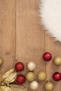 Christmas background. Gold Christmas balls on a wooden background. Winter holidays concept. Top view with copy space, vertical