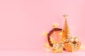 Christmas background in gold glitter color - Christmas tree, wreath, balls, bowl and glowing star lights on light pink background. Royalty Free Stock Photo