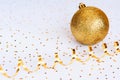 Christmas background. Golden ball, gold streamer and stars on white background. Christmas card. Copy space Royalty Free Stock Photo