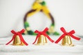 Christmas background, golden bells with red ribbon