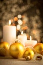 Christmas background with golden boubles and candles