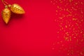 Christmas background with golden cones, festive balls. New Year card, frame. Decoration, design. Top view. Red mockup. Text space.