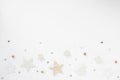 Christmas background. Golden stars, bells and bows on white background. Flat lay, top view, copy space Royalty Free Stock Photo