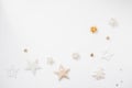 Christmas background. Golden stars, bells and bows on white background. Flat lay, top view, copy space Royalty Free Stock Photo