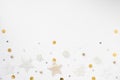 Christmas background. Golden stars, bells and bows on white background. Flat lay, top view, copy space Royalty Free Stock Photo