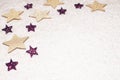 Christmas background, with golds and purple glitter stars and sn