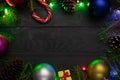 Christmas background, green fir branches, red and blue , pink, golden balls, candies, cone, garland, gift box, black boards Royalty Free Stock Photo