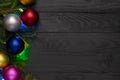 Christmas background, green fir branches, red and blue, pink, golden balls, garland, black boards Royalty Free Stock Photo