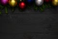 Christmas background, green fir branches, red and blue, pink, yellow balls, , black boards Royalty Free Stock Photo