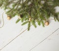 Christmas background. Green spruce branches on a wooden white background.