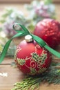 Christmas background, greeting card. Red beautiful bauble with green ribbon, fir branches, winter decoration, gift boxes over Royalty Free Stock Photo