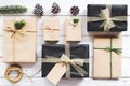 Christmas background with handmade present gift boxes and rustic decoration on white wooden board. Royalty Free Stock Photo