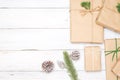 Christmas background with handmade present gift boxes and rustic decoration on white wooden board. Royalty Free Stock Photo