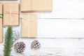 Christmas background with handmade present gift boxes and rustic decoration on white wooden board. Royalty Free Stock Photo