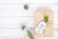 Christmas background with handmade present gift boxes and rustic decoration on white wooden board. Royalty Free Stock Photo