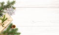 Christmas background. Happy New Year composition. Christmas gift, pine cones, fir branches on wooden white floor