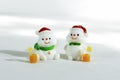 Christmas background. Happy snowmen with tropical drinks, on a white background with hard shadows. Merry christmas and happy new
