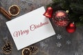 Christmas background with holiday festive decorations and Merry Christmas text on dark background Royalty Free Stock Photo