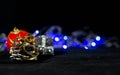 Christmas background image, red ball on the blurred background, blue lights, focus on the pine cone Royalty Free Stock Photo