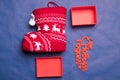 Christmas background with the inscription in Russian New Year`s studio image. Red gift box with christmas sock on a blue backgroun