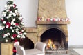Christmas background interior of a warm house with a decorated Christmas tree and a burning fireplace fire. Cozy festive interior Royalty Free Stock Photo